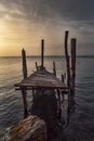 Old ruined pier on Lake Garda at sunset Royalty Free Stock Photo