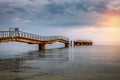 Old ruined pier in the sea under stormy clouds Royalty Free Stock Photo