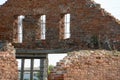 Old ruined stone house in the village. Red brick house built in the last century. Historical value. Demolition of buildings Royalty Free Stock Photo