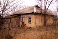 Old ruined village house. Window frame, broken glass, peeling paint. Royalty Free Stock Photo