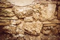 Old ruined wall. Shell rock, plaster and natural stone. Royalty Free Stock Photo