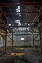 Old ruined warehouse that was almost demolished. The sky can be seen through the roof. Royalty Free Stock Photo