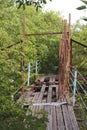 Old ruined wooden bridge across a small river Royalty Free Stock Photo