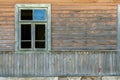 An old ruined wooden house in the village. Details of the facade of a historic wooden house with carved shutters and vintage decor