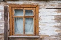 An old ruined wooden house in the village. Details of the facade of a historic wooden house with carved shutters and vintage decor