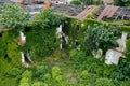 Old ruins of historical building overgrown by vegetation green post-apocalyptic concept