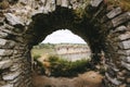 Old ruins of Skala Podilskyi castle, Ukraine. Destroyed ruined stone walls of medieval castle and green grass, historical defence Royalty Free Stock Photo