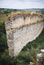 Old ruins of Skala Podilskyi castle, Ukraine. Destroyed ruined stone walls of medieval castle and green grass, historical defence Royalty Free Stock Photo