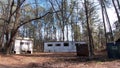 Old run down dilapidated trailer park and dumpsters