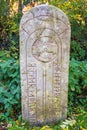 Old Runestone with runes and a cross in nature Royalty Free Stock Photo