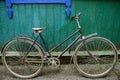 Old, rural bicycle near a wooden green wall Royalty Free Stock Photo