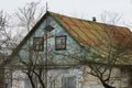 Old rural house with blue attic and small windows Royalty Free Stock Photo