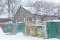 Old rural house. Old metal gate with a deer pattern. Winter landscape Royalty Free Stock Photo