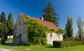 Old rural house overgrown with green ivy Royalty Free Stock Photo