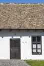 Old rural house with tiled roof, window and wooden door in the ethnographic village of Holloko in Hungary, Europe Royalty Free Stock Photo