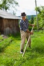 Old rural man using scythe Royalty Free Stock Photo