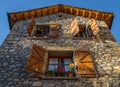 Old rural stone house in the Pyrenees with open wooden windows and precious pots. The light of the late afternoon Royalty Free Stock Photo