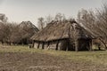 An old rural thatched-roofed farmhouse built of logs