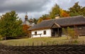 Old rural wooden house with thatched roof. Fall season. Close-up Royalty Free Stock Photo