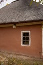 Old rural wooden house with thatched roof. Fall season. Close-up Royalty Free Stock Photo