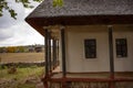 Old rural wooden house with thatched roof. Fall season. Close-up Royalty Free Stock Photo