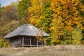 Old rural wooden house with thatched roof. Fall season. Close-up Royalty Free Stock Photo