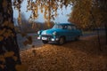 Soviet oldtimer Volga in the autumn forest