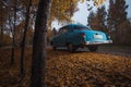 Soviet oldtimer Volga in the autumn forest