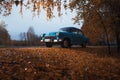 Soviet oldtimer Volga in the autumn forest