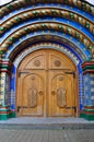 Old Russian heavy wooden doors of brown color. Arch