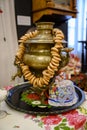 An old Russian samovar with dryers and a traditional doll