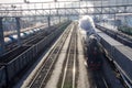 Old Russian steam train rushing , locomotives of other trains standing nearby. Siberia, Russia Royalty Free Stock Photo