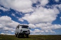 Old russian touristic minibus standing on green grass field