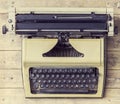 Old Russian typewriter over retro wooden background. Vintage equipment.