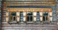 Old russian wooden house with decorated windows