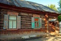 Old russian wooden log house with window shutters and door Royalty Free Stock Photo