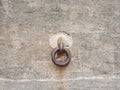 Old and rust chain link attached to a concrete wall