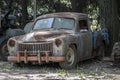 An old, rusted, abandoned car.