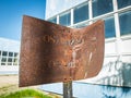 An old, rusted and bent sign