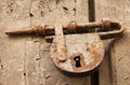 Old Rusted Bolt and Padlock on Wooden Door