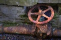 Old Rusted and Broken Water Pipe with Turn Wheel Valve Royalty Free Stock Photo