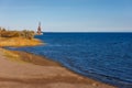 old rusted dock crane on mountain lake Issyk-Kul at sunny autumn afternoon