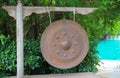 Old rusted gong - Traditional ancient instrument hanging in the midst of nature