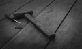 Old rusted hammer, screwdriver and nail on old wooden table. Woodwork tools for fix and repair home. Carpentry tools on an old