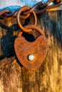 Old rusted heart shaped padlock on a loop chain Royalty Free Stock Photo