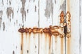 Old rusted hinge on a white door Royalty Free Stock Photo