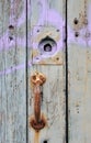 Old rusted iron door handle on a green painted wooden door Royalty Free Stock Photo