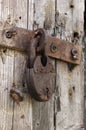 Old rusted lock on a rustic door with decorative natural weathered wood planks Royalty Free Stock Photo