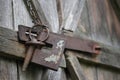 Old rusted lock on weathered wooden barn door. Royalty Free Stock Photo