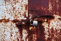 Old rusted lock on a white and brown rusty gate. Royalty Free Stock Photo